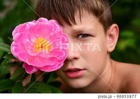 Portrait of a teenager boy with a flower in his Portrait of a teenager boy with a flower in his 66953877