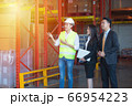 Businessman and engineer talking in the factory 66954223