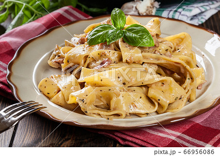 Pappardelle pasta with prosciutto and cheese sauce 66956086