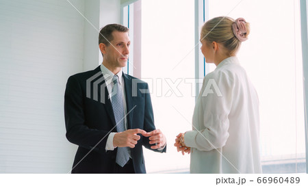 Two business people talk project strategy at office 66960489