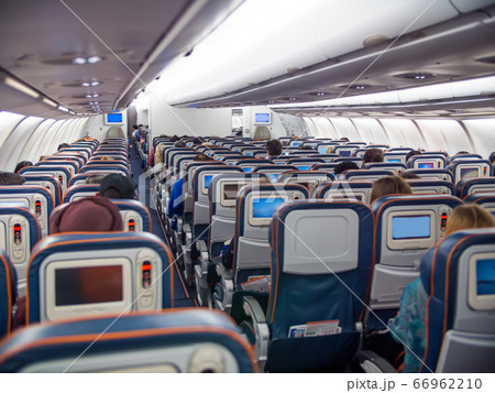 The cabin with passengers during the flight. The cabin with passengers during the flight. 66962210