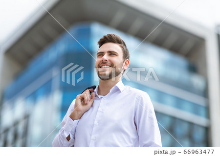 Attractive businessman in downtown area of modern metropolis city Attractive businessman in downtown area of modern metropolis city 66963477