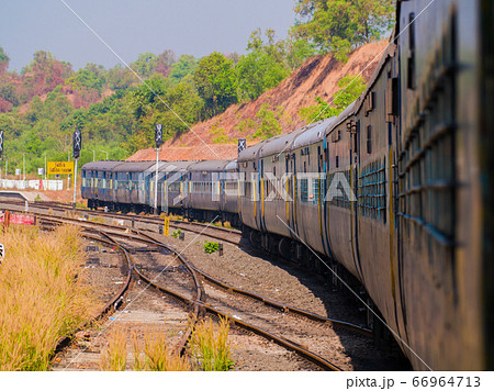 A traditional train carriage in India in transit. 66964713