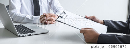 Employer or committee holding reading a resume Employer or committee holding reading a resume 66965673