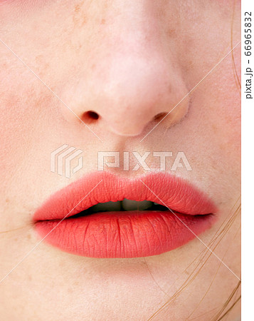 Close Up face detail. Perfect natural lip makeup. Beautiful female face with cute freckles in soft daylight. 66965832