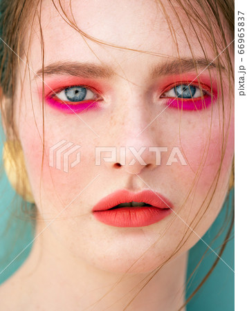 Sensual portrait of red-haired girl close-up on pink background. Beauty fashion concept. Summer mood. Sensual portrait of red-haired girl close-up on pink background. Beauty fashion concept. Summer mood. 66965837