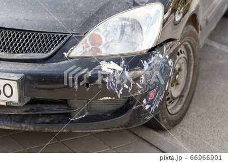Broken bumper on a black car. Dirty car after an accident. Broken bumper on a black car. Dirty car after an accident. 66966901