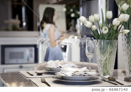 preparing dishware on romantic dinner table preparing dishware on romantic dinner table 66967140