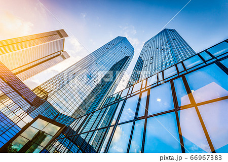 Modern skyscrapers in business district at sunset against blue sky 66967383