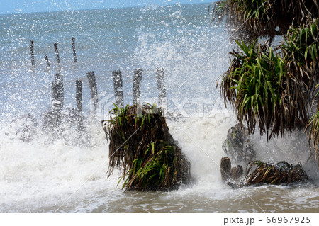 Big waves crushing on shore of a tropical island Big waves crushing on shore of a tropical island 66967925