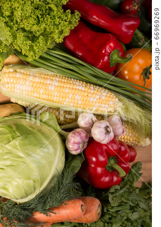 Assortment of fresh raw vegetables on a wooden table. Healthy food Top view background with empty space. 66969269