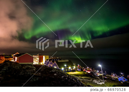 Green bright northern lights hidden by the clouds Green bright northern lights hidden by the clouds 66970528