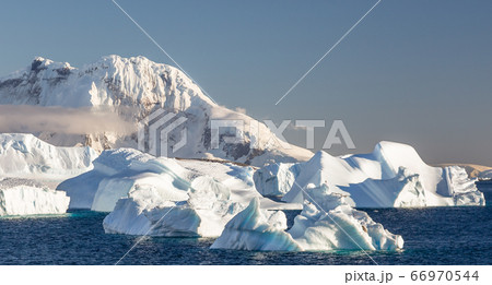 Icebergs on the still waters of Cuverville island Icebergs on the still waters of Cuverville island 66970544