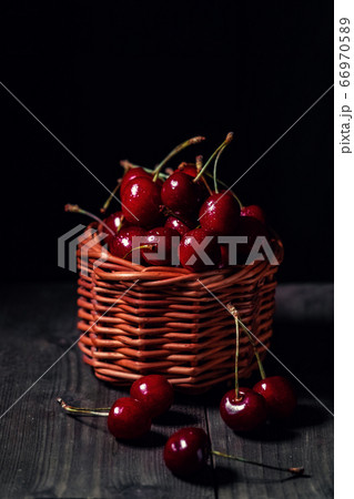 Cherry in dew drops is in a basket 66970589