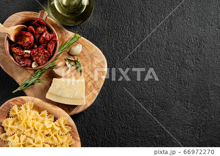 Ingredients for pasting pasta with sun-dried tomatoes and parmesan. Italian Cuisine. Image with copy space 66972270