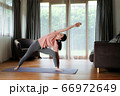Asian woman doing yoga exercise in living room at home,health care and workout concept. 66972649