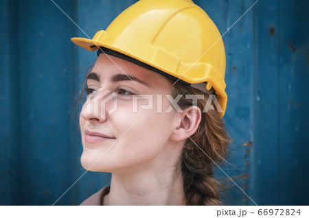 Portrait of Confident Transport Engineer Woman in Safety Equipment Standing in Container Ship Yard Portrait of Confident Transport Engineer Woman in Safety Equipment Standing in Container Ship Yard 66972824