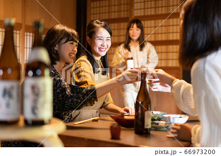 日本酒で乾杯する女性の写真素材