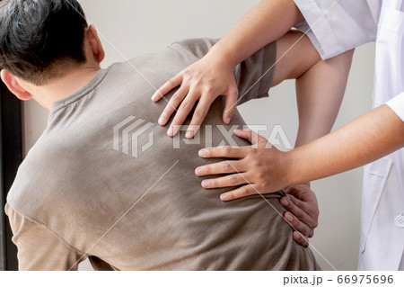 Female physiotherapists provide physical assistance to male patients with back injuries back massages for relaxation and muscle recovery in the rehabilitation center Female physiotherapists provide physical assistance to male patients with back injuries back massages for relaxation and muscle recovery in the rehabilitation center 66975696