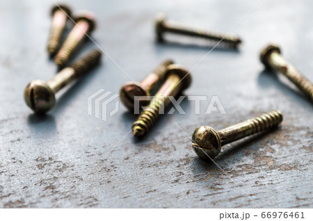 Screw on rusty metallic surface. Close Up. Screw on rusty metallic surface. Close Up. 66976461