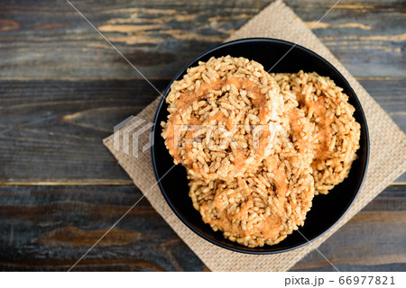 Deep fried sweet crispy rice with cane sugar drizzle, Local Thai snack (Khao Tan) Deep fried sweet crispy rice with cane sugar drizzle, Local Thai snack (Khao Tan) 66977821