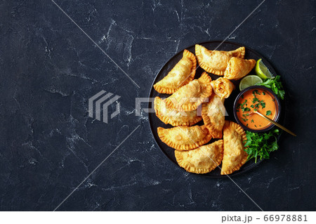Buffalo Chicken Empanadas on a black plate Buffalo Chicken Empanadas on a black plate 66978881