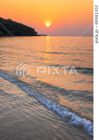 Beautiful early sunset over and Wave of the sea on 66981302