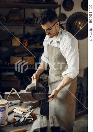 Handsome carpenter working with a wood 66981419