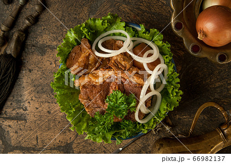 meat dish on an old paving stone 66982137