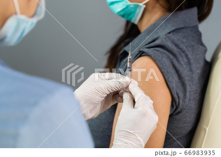 doctor in gloves holding syringe and making 66983935
