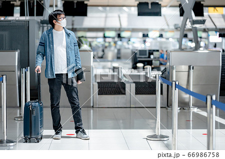 Asian man tourist wearing mask in airport terminal 66986758