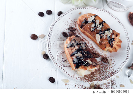 Tasty eclairs on table 66986992