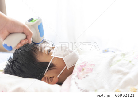 非接触式体温計で検温される男の子 66992121