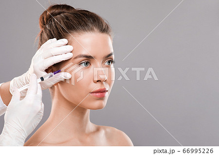 Young woman getting facial beauty injection for wrinkles Young woman getting facial beauty injection for wrinkles 66995226