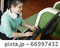 Asian young blind woman using computer  66997432