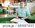Asian young blind woman disabled person reading Braille book 66997433