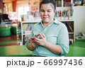 Asian young blind woman using smart phone  66997436