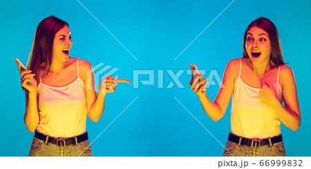 Caucasian young woman's portrait isolated on blue background in neon light 66999832
