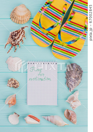 Holiday vacation travel concept with seashells and beach sandals on a blue background. 67002845