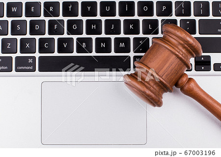 Laptop computer with legal court gavel on keyboard. 67003196
