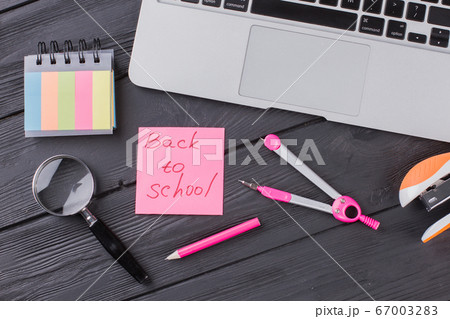 Stationary clerical items on the dark wooden table. Stationary clerical items on the dark wooden table. 67003283