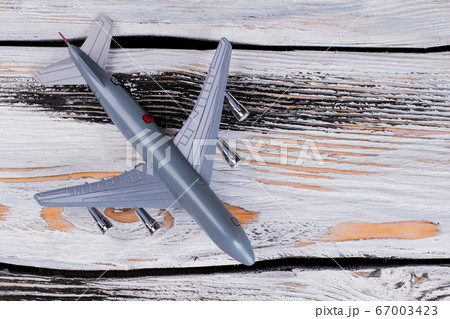Toy model of passenger plane on wooden table. Toy model of passenger plane on wooden table. 67003423