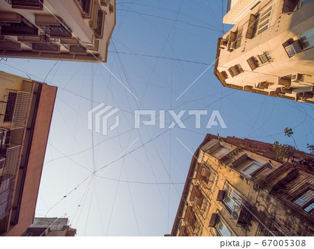 Electric wires hanging on the buildings in Mumbai. Electric wires hanging on the buildings in Mumbai. 67005308