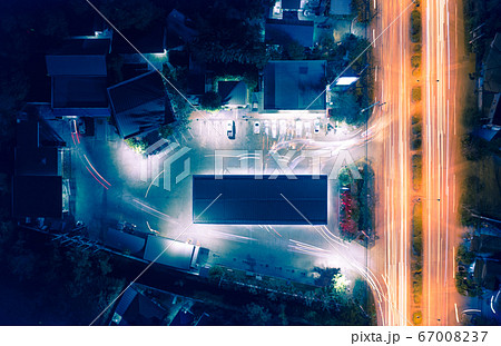 Aerial view of light of car on road and car park 67008237