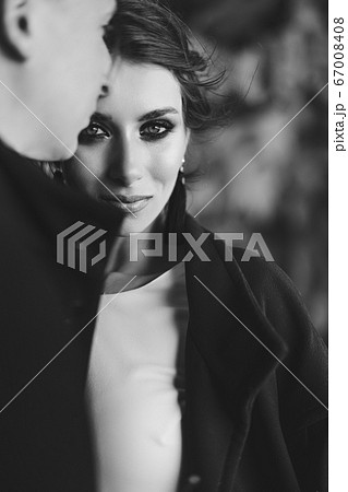 Close-up portrait of a bride hugging with the groom. Beautiful expressive eyes. Wedding couple on a black and white photo. Destination Iceland wedding. Close-up portrait of a bride hugging with the groom. Beautiful expressive eyes. Wedding couple on a black and white photo. Destination Iceland wedding. 67008408