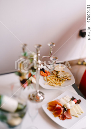 Breakfast plates on the table - cheese and meat slicing, toast and fries. Breakfast plates on the table - cheese and meat slicing, toast and fries. 67009151