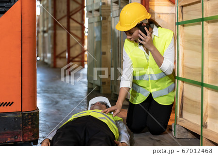 Warehouse worker call ambulance after accident 67012468