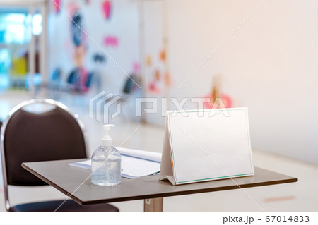 Clear alcohol gel bottles for hand cleaning to prevent the spreading of the corona virus (Covid-19). Place the entrance service with register book for customers before buying in the supermarket. 67014833