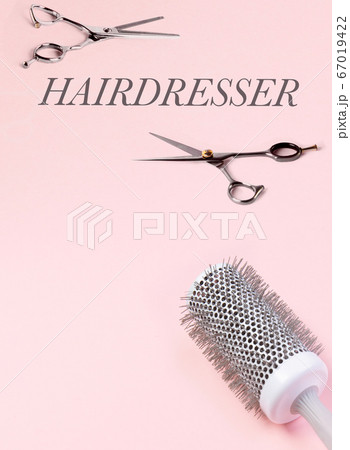 Several hairdresser tools. Scissors and hairbrush. On a pink background. Several hairdresser tools. Scissors and hairbrush. On a pink background. 67019422