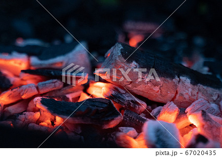 Hot sparking live-coals burning in a barbecue Hot sparking live-coals burning in a barbecue 67020435